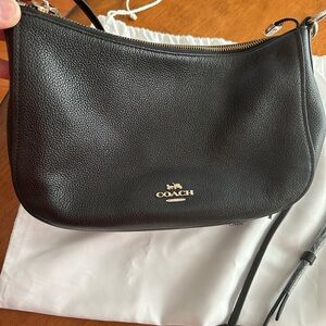 Coach Black Shoulder Bag with Leather and Curved Design. Strap included.